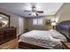Well-lit main bedroom with wood floors, a ceiling fan, and a spacious layout at 308 E La Jolla Dr, Tempe, AZ 85282