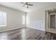 Bright bedroom with wood floors, a ceiling fan, and wainscoting at 3280 E Coconino Dr, Gilbert, AZ 85298