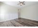 Bright bedroom with wood floors, a ceiling fan, and wainscoting at 3280 E Coconino Dr, Gilbert, AZ 85298