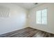 The bedroom is shown with dark floors and a single window that lets in natural light at 3280 E Coconino Dr, Gilbert, AZ 85298
