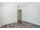 Bedroom with wood-look floors, large closet with double doors, and doorway to an adjacent room at 3280 E Coconino Dr, Gilbert, AZ 85298