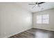 Bright bedroom with hardwood floors, ceiling fan, and window at 3280 E Coconino Dr, Gilbert, AZ 85298
