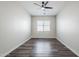 Neutral bedroom with wood-look flooring, ceiling fan, and window creating an inviting space at 3280 E Coconino Dr, Gilbert, AZ 85298