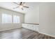 Bedroom features wood-look floors, two windows, and custom built-in cabinets with a countertop at 3280 E Coconino Dr, Gilbert, AZ 85298
