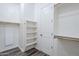 Bright, spacious walk-in closet features wood floor, white walls, shelves and a door at 3280 E Coconino Dr, Gilbert, AZ 85298