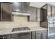 Contemporary kitchen featuring granite counters, stainless steel appliances, and stone backsplash at 3280 E Coconino Dr, Gilbert, AZ 85298