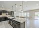 Open kitchen featuring a large center island, granite countertops, and modern appliances at 3280 E Coconino Dr, Gilbert, AZ 85298