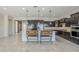 The kitchen is designed with dark wood cabinets, granite countertops, and barstool seating at the island at 3280 E Coconino Dr, Gilbert, AZ 85298