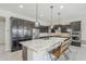 A spacious kitchen is shown with granite countertops, stainless steel appliances, and dark cabinets at 3280 E Coconino Dr, Gilbert, AZ 85298