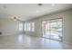 A bright living room has tile flooring, large windows, and a sliding door with a view of the pool at 3280 E Coconino Dr, Gilbert, AZ 85298