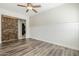 Bright living room with wood-look floors, barn door, and wainscoting details at 3280 E Coconino Dr, Gilbert, AZ 85298