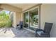 Covered patio with two chairs and tile floor, overlooking backyard and pool at 3280 E Coconino Dr, Gilbert, AZ 85298