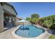Sparkling pool with umbrella, lush landscaping, and travertine tile surround create backyard oasis at 3280 E Coconino Dr, Gilbert, AZ 85298