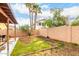 Landscaped backyard with green grass, mature trees, patio, and privacy wall, ideal for outdoor living and entertaining at 3353 E Blackhawk Dr, Phoenix, AZ 85050