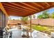 Large backyard featuring a covered patio, green grass, a grilling area, and block wall for privacy at 3353 E Blackhawk Dr, Phoenix, AZ 85050