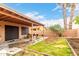 Spacious backyard featuring a covered patio and mature trees, perfect for outdoor entertaining and grilling at 3353 E Blackhawk Dr, Phoenix, AZ 85050