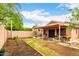Spacious backyard featuring a covered patio, perfect for outdoor dining and entertaining with a privacy fence at 3353 E Blackhawk Dr, Phoenix, AZ 85050