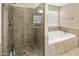 Bathroom features a shower and a tub with tile surround at 3353 E Blackhawk Dr, Phoenix, AZ 85050