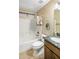 A bathroom features a vanity with a granite countertop and a white tiled shower-over-tub combo at 3353 E Blackhawk Dr, Phoenix, AZ 85050