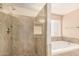 Bathroom with tiled shower and a soaking tub at 3353 E Blackhawk Dr, Phoenix, AZ 85050