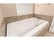 Soaking tub with jets, neutral wall paint and tiled surround at 3353 E Blackhawk Dr, Phoenix, AZ 85050
