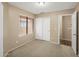 Bedroom featuring plush carpet, a window, and a closet at 3353 E Blackhawk Dr, Phoenix, AZ 85050