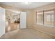 Bright bedroom featuring plush carpet and view to a living room at 3353 E Blackhawk Dr, Phoenix, AZ 85050