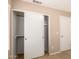 Bedroom with large closet featuring white sliding doors at 3353 E Blackhawk Dr, Phoenix, AZ 85050