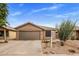 Home exterior featuring desert landscaping, neutral color palette and a two-car garage at 3353 E Blackhawk Dr, Phoenix, AZ 85050