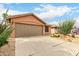 Single-story home with xeriscaping, a two-car garage, and a concrete driveway at 3353 E Blackhawk Dr, Phoenix, AZ 85050