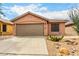Charming single-story home featuring a xeriscaped front yard and a two-car garage at 3353 E Blackhawk Dr, Phoenix, AZ 85050