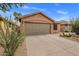 Home exterior showcasing a two-car garage, desert landscaping and a neutral color scheme at 3353 E Blackhawk Dr, Phoenix, AZ 85050