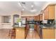 Well-equipped kitchen with an island, sleek appliances, granite countertops, and wood cabinets at 3353 E Blackhawk Dr, Phoenix, AZ 85050