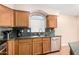Kitchen with stainless steel appliances, granite countertops, wood cabinets, and undermount sink at 3353 E Blackhawk Dr, Phoenix, AZ 85050