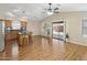 Spacious living area seamlessly connects kitchen and patio, with wood floors and ample natural light at 3353 E Blackhawk Dr, Phoenix, AZ 85050