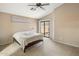 Comfortable main bedroom featuring plush carpet, ceiling fan, and a sliding door to a patio at 3353 E Blackhawk Dr, Phoenix, AZ 85050