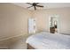 Comfortable main bedroom featuring carpet, a fan, and a door to a bathroom at 3353 E Blackhawk Dr, Phoenix, AZ 85050