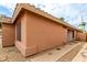 Exterior view showcasing the side of the home with stucco siding and a walkway at 3353 E Blackhawk Dr, Phoenix, AZ 85050