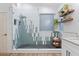Stylish bathroom featuring a walk-in shower with decorative tile, modern fixtures, and floating shelves at 3604 E Derringer Way, Gilbert, AZ 85297