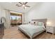 Bright bedroom features a sliding glass door and contemporary furniture including a gray upholstered bed at 3604 E Derringer Way, Gilbert, AZ 85297