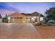 Inviting home exterior with a three-car garage, a well-manicured lawn, and a vibrant red front door at 3604 E Derringer Way, Gilbert, AZ 85297