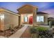 Charming home exterior featuring a vibrant red door and beautifully landscaped front yard with desert plants at 3604 E Derringer Way, Gilbert, AZ 85297