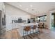 Bright kitchen featuring white cabinets, stainless steel appliances, a large island, and a stylish backsplash at 3604 E Derringer Way, Gilbert, AZ 85297