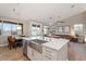 Open kitchen design with stainless steel appliances, large central island, and connected living area at 3604 E Derringer Way, Gilbert, AZ 85297