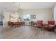Bright living room boasts modern decor, dining table, musical instruments, and sleek wood-style flooring at 3604 E Derringer Way, Gilbert, AZ 85297
