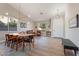Bright and open-concept living and dining area with modern lighting and stylish furnishings at 3604 E Derringer Way, Gilbert, AZ 85297