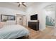 Spacious primary bedroom with wood-look tile flooring, ensuite bathroom, and ample closet space at 3604 E Derringer Way, Gilbert, AZ 85297