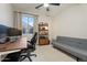 Well-lit home office with a modern desk, comfortable chair, and a futon at 3604 E Derringer Way, Gilbert, AZ 85297