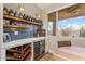 Chic wet bar area with wine storage, custom shelving, and elegant countertops, ideal for entertaining guests at 3604 E Derringer Way, Gilbert, AZ 85297