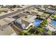 Aerial view of a landscaped backyard featuring a sparkling pool, covered patio, and mature trees at 3754 W Hearn Rd, Phoenix, AZ 85053